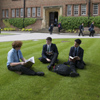 Boys sitting in front of the School